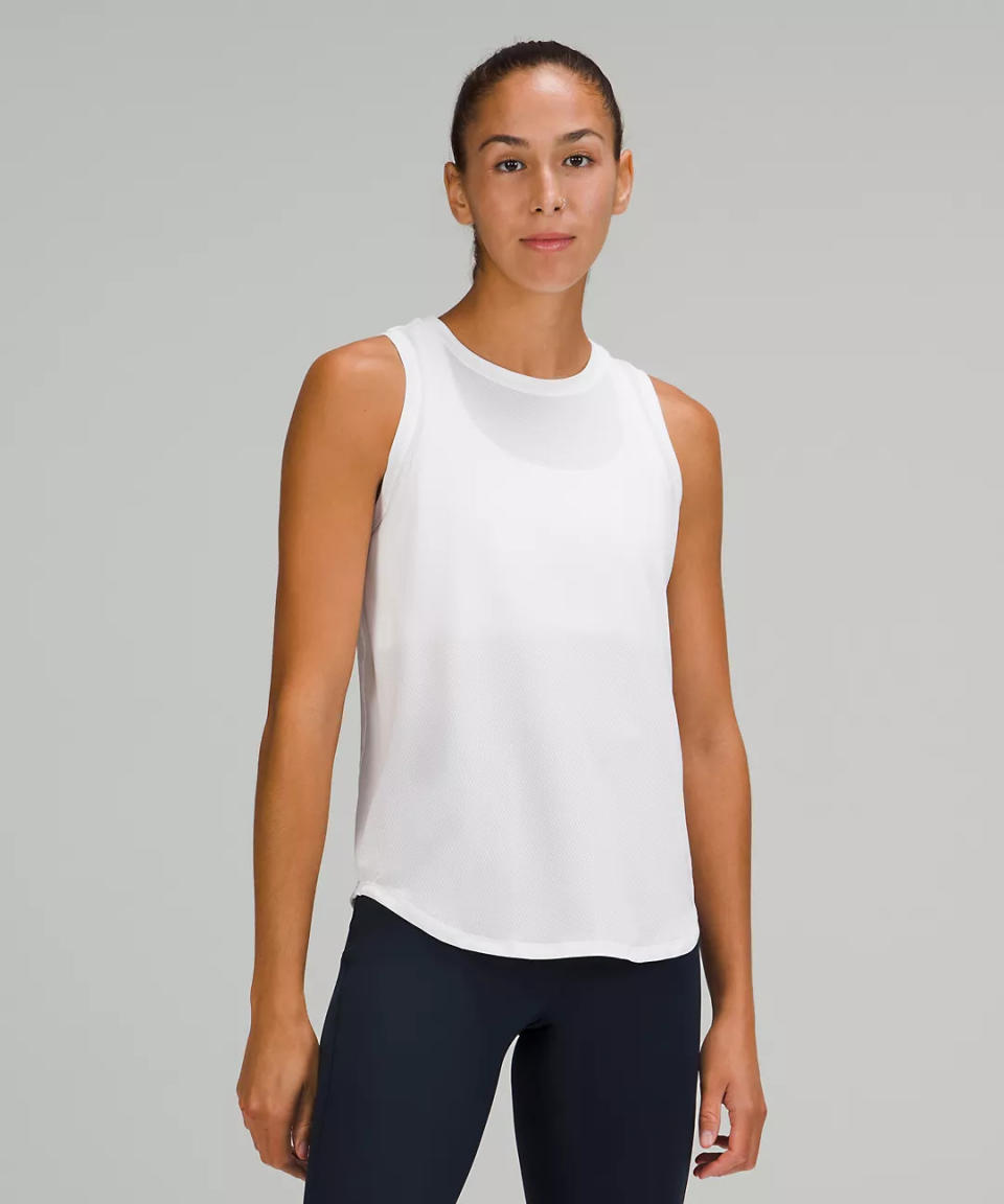 model wears white High-Neck Running and Training Tank Top. 