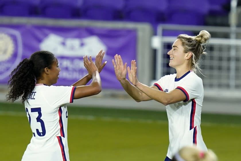 United States midfielder Kristie Mewis, right, celebrates her goal against Colombia with defender Margaret Purce.