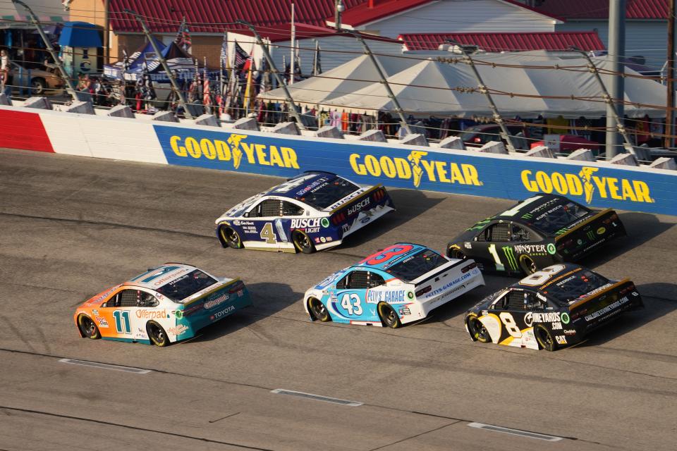 NASCAR Cup Series drivers race past the Goodyear signs at Darlington Raceway.
