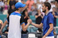 Jannik Sinner, of Italy, left, shakes hands with Daniil Medvedev, of Russia, right, after winning their semifinal match at the Miami Open tennis tournament, Friday, March 29, 2024, in Miami Gardens, Fla. (AP Photo/Lynne Sladky)