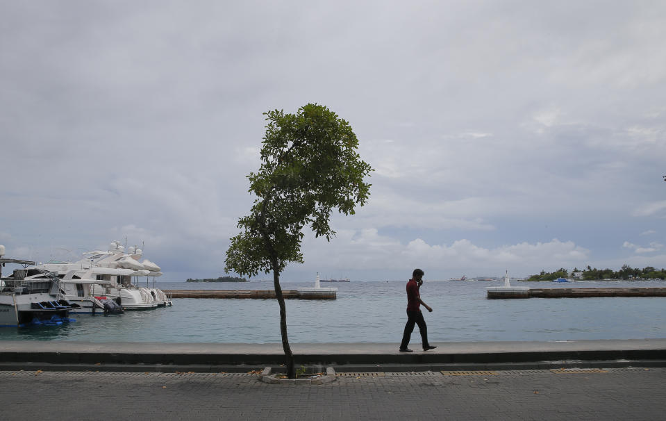 A Maldivian man walks on a street in Male, Maldives, Monday, Sept. 24, 2018. Opposition candidate Ibrahim Mohamed Solih declared victory early Monday in the Maldives' contentious presidential election, which was widely seen as a referendum on the island nation's young democracy. Famed for its sandy white beaches and luxury resorts, the nation of islands and atolls in the southern Indian Ocean has seen economic growth and longer life expectancy under strongman President Yameen Abdul Gayoom, according to the World Bank. But democratic freedoms have been curtailed. (AP Photo/Eranga Jayawardena)