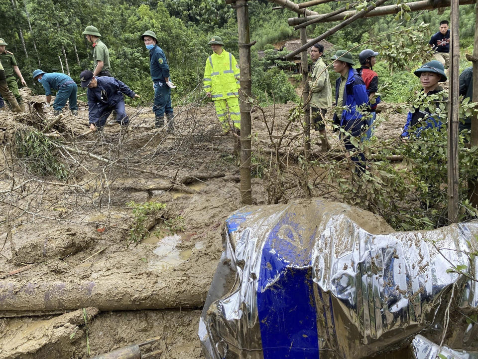 Rescue workers clear mud and debris brough down by a flood in Lang Nu hamlet in Lao Cai province, Vietnam Tuesday, Sep. 10, 2024. (Pham Hong Ninh/VNA via AP)