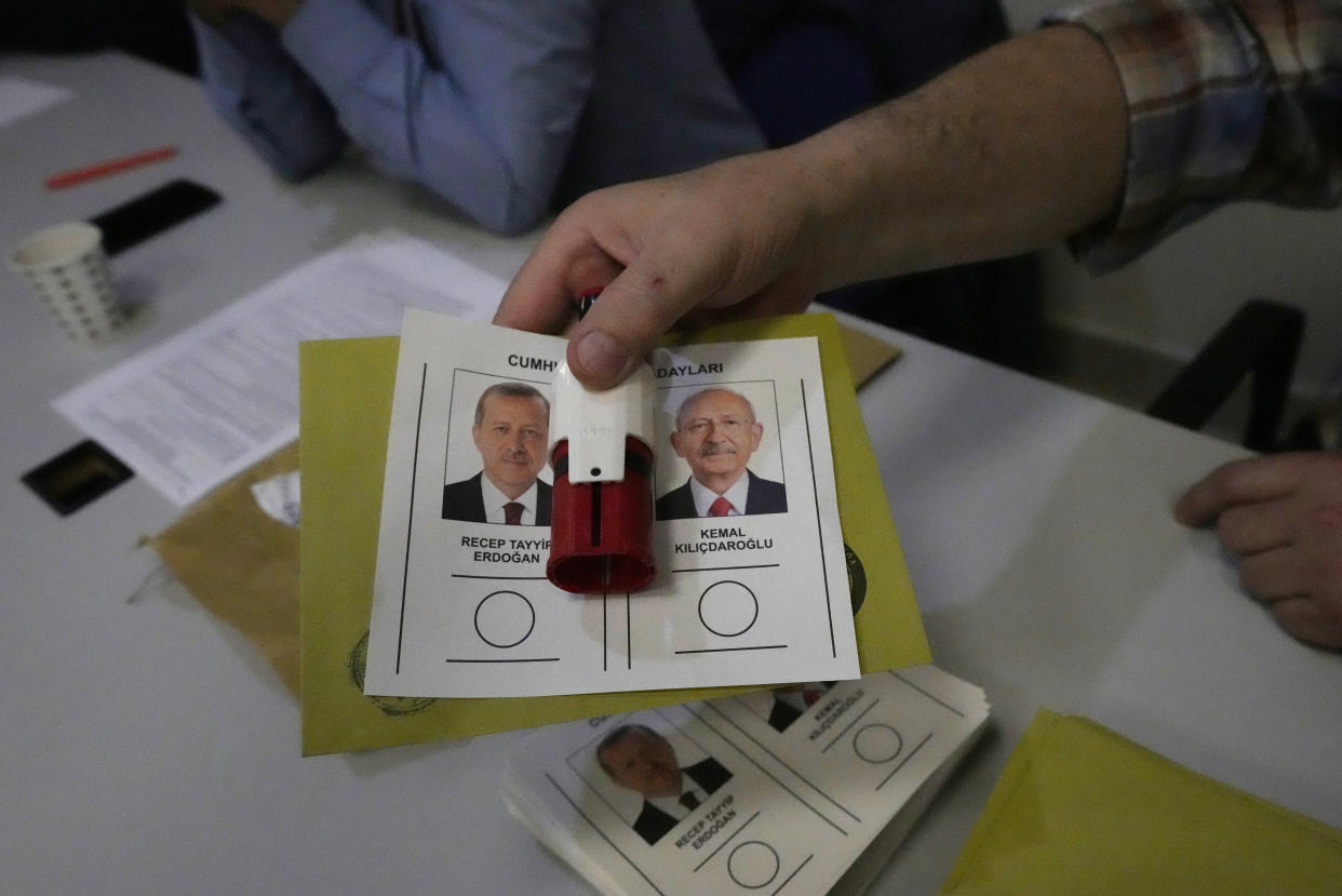 An official prepares a ballot with the names and images of the two presidential candidates, Recep Tayyip Erdogan, left, and Kemal Kilicdaroglu, at a polling station, in Ankara, Turkey, Sunday, May 28, 2023. Voters in Turkey returned to the polls Sunday to decide whether the country’s longtime leader, Erdogan, stretches his increasingly authoritarian rule into a third decade or is unseated by a challenger who has promised to restore a more democratic society. (AP Photo/Burhan Ozbilici)