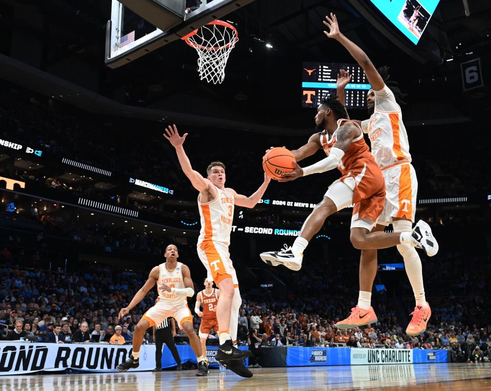 Texas guard Tyrese Hunter, center, passes the ball during the Longhorns' 62-58 loss to Tennessee in a second-round game of the NCAA Tournament Saturday in Charlotte, N.C. Hunter, a junior, said he will likely explore his NBA options before making a decision about his senior year.