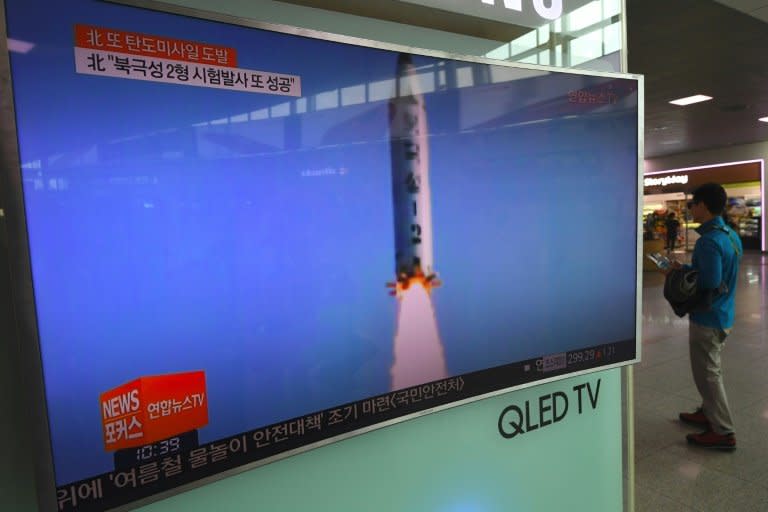 A man walks past a television showing a news report on North Korea's latest missile test in Seoul