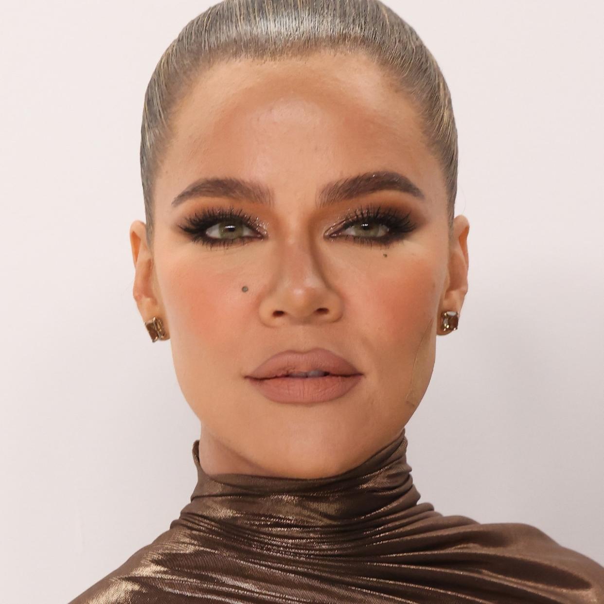  Close up shot of Khloe Kardashian with hair pulled back, heavy eye makeup 