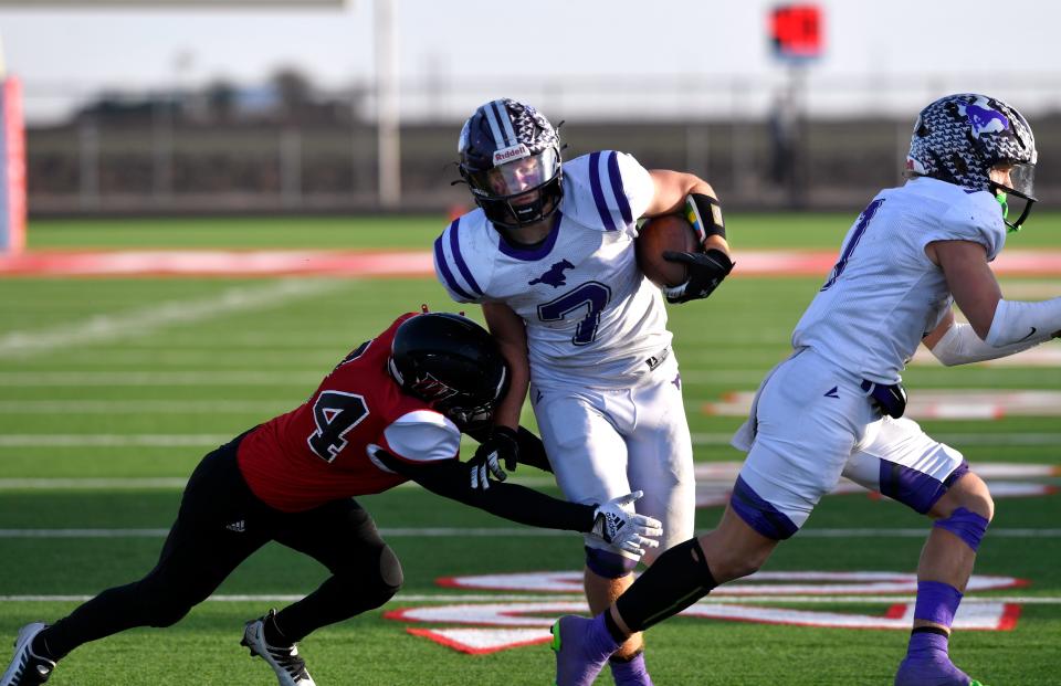 Benjamin running back Brody White slips through a Whitharral tackle during Saturday's Class 1A Division II six-man semifinal playoff in Hermleigh.