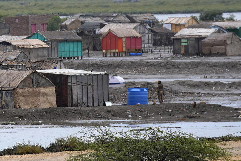 A paramilitary soldier searches an empty village to ensure everybody have been evacuated due to Cyclone Biparjoy approaching, in Keti Bandar near Thatta, Pakistan's southern district in the Sindh province, Wednesday, June 14, 2023. The coastal regions of India and Pakistan were on high alert Wednesday with tens of thousands being evacuated a day before Cyclone Biparjoy was expected to make landfall. (AP Photo/Fareed Khan)