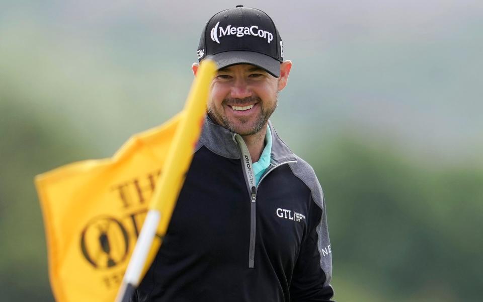 United States'  Brian Harman smiles after he chips onto the 5th green/The Open leaderboard: Full scores from Hoylake in 2023