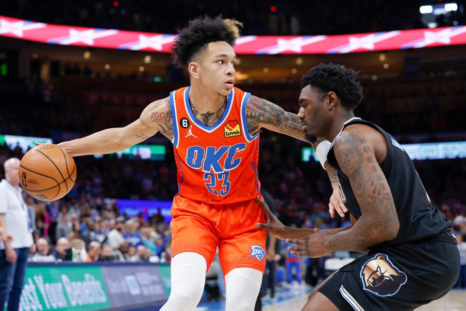 The Thunder's Tre Mann drives against Memphis' Vince Williams Jr. on Sunday in Paycom Center. ALONZO ADAMS/USA Today Sports