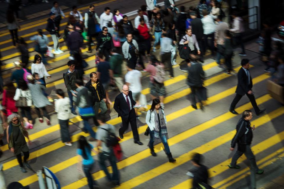 Pedestrians cross a road in the Central district of Hong Kong, China, on Wednesday, Nov. 22, 2017. (David Paul Morris/Bloomberg)