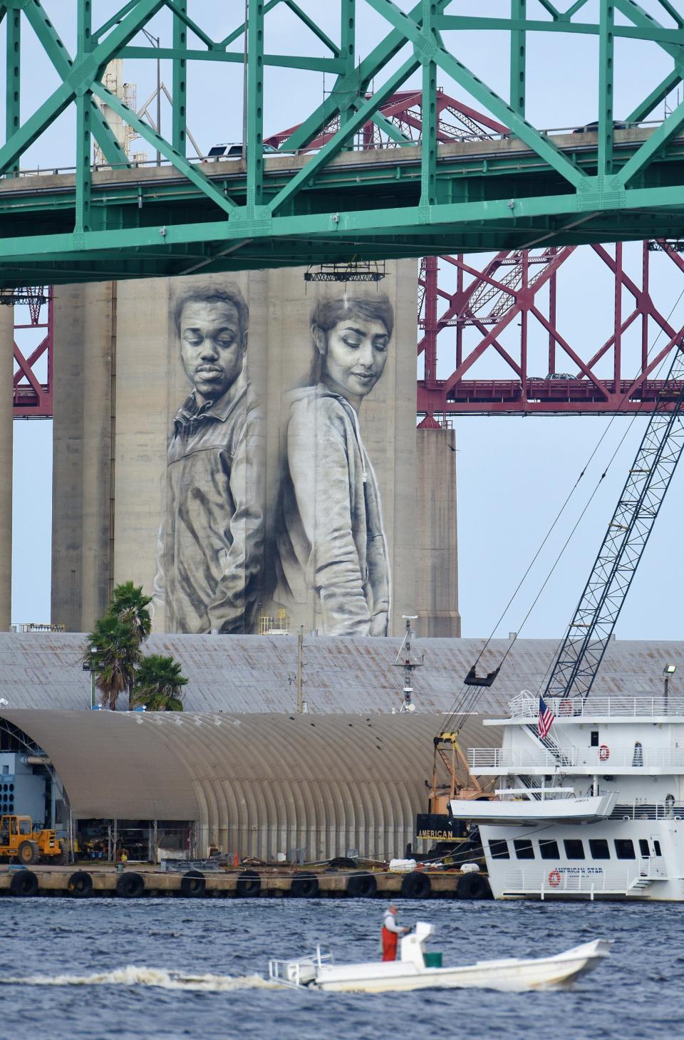 Towering between the Hart and the Mathews bridges, this mural of Connell Crooms and Sara Mahmoud was still a work in progress by artist Guido van Helten in this 2016 photo.