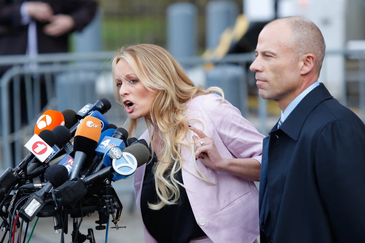 Adult film actor Stephanie Clifford, also known as Stormy Daniels, speaks outside US Federal Court with her then-lawyer Michael Avenatti in 2018 (AFP via Getty Images)