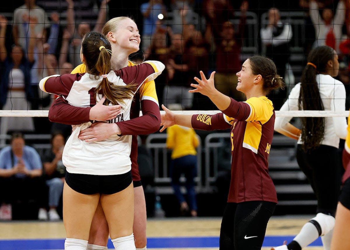 Teammates hug McKenna Wucherer after Minnesota upset top-ranked Texas on Monday at Fiserv Forum.