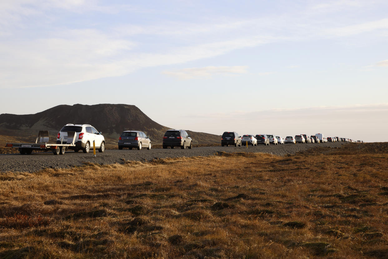 Cars lined up on a road.