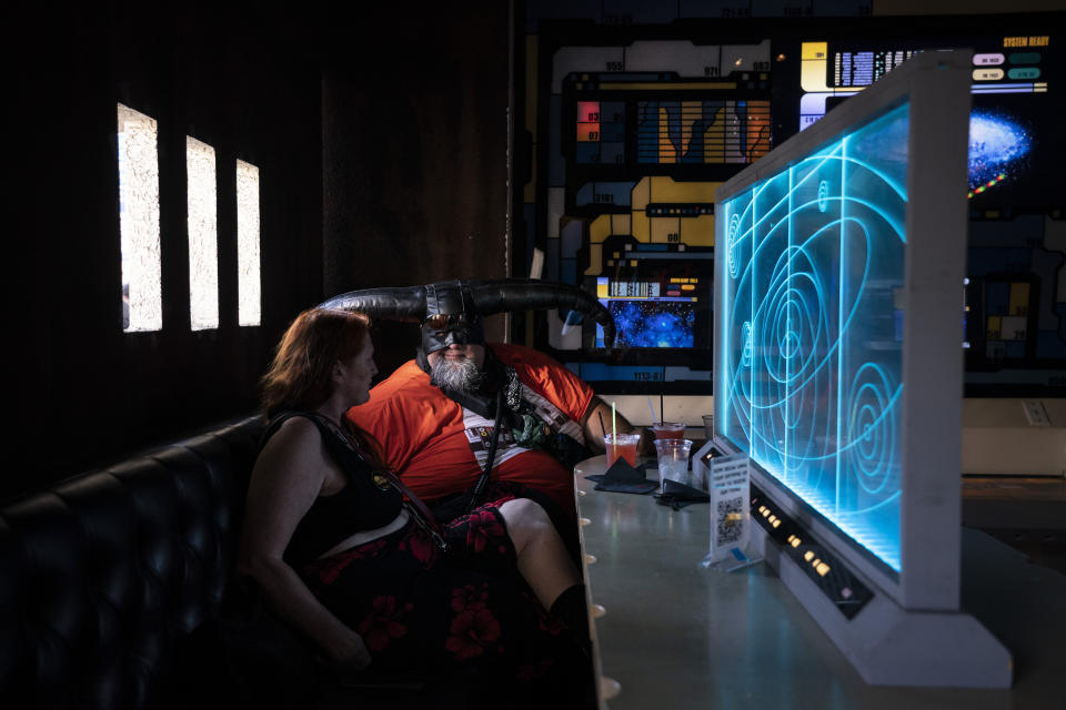 Candice Tate, left, and her boyfriend Brandon Daniels celebrate Star Wars Day at Scum and Villainy Cantina, a geek bar located on Hollywood Boulevard in Los Angeles, Tuesday, May 4, 2021. California has the lowest infection rate in the country. Los Angeles County, which is home to a quarter of the state's nearly 40 million people and has endured a disproportionate number of the state's 60,000 deaths, didn't record a single COVID-19 death Sunday or Monday, which was likely due to incomplete weekend reporting but still noteworthy. (AP Photo/Jae C. Hong)