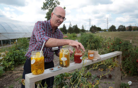 Dr. Brian Halloran. a vascular surgeon at Saint Joseph Mercy Ann Arbor, shows the canned vegetables from his garden across from Saint Joseph Mercy hospital in Ypsilanti, Michigan, U.S., August 23, 2017. REUTERS/Rebecca Cook