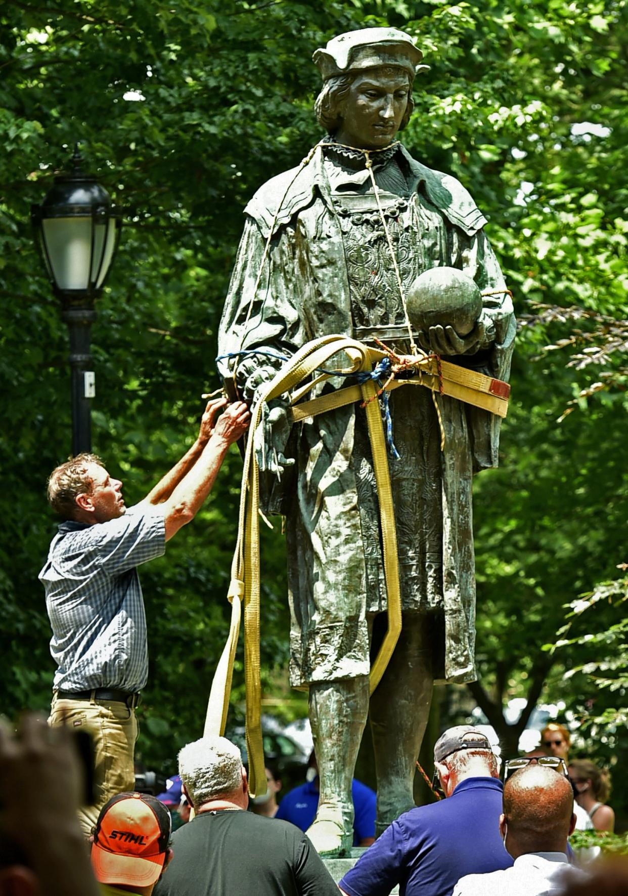 A statue of Christopher Columbus is removed from Wooster Square Park in New Haven, Conn. on Wednesday, June 24, 2020.
