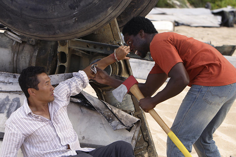 Harold and Daniel Dae Kim next to wreckage in a scene from Lost