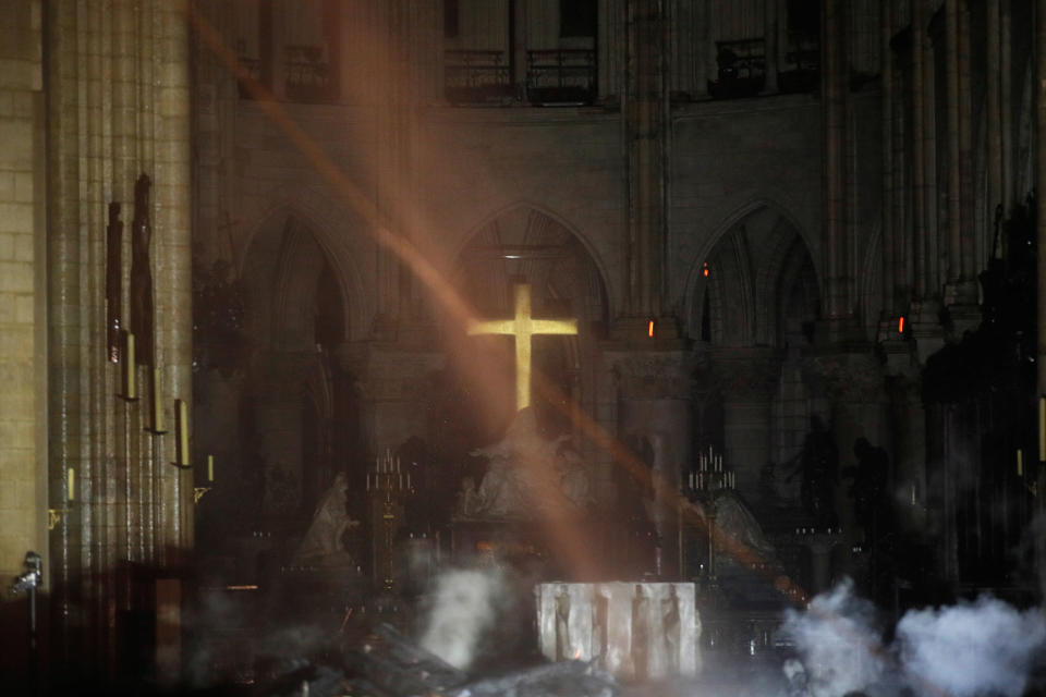 Smoke rises around the altar in front of the cross inside the Notre Dame Cathedral as a fire continues to burn in Paris, France, April 16, 2019.   (Photo: Philippe Wojazer/Pool/Reuters)