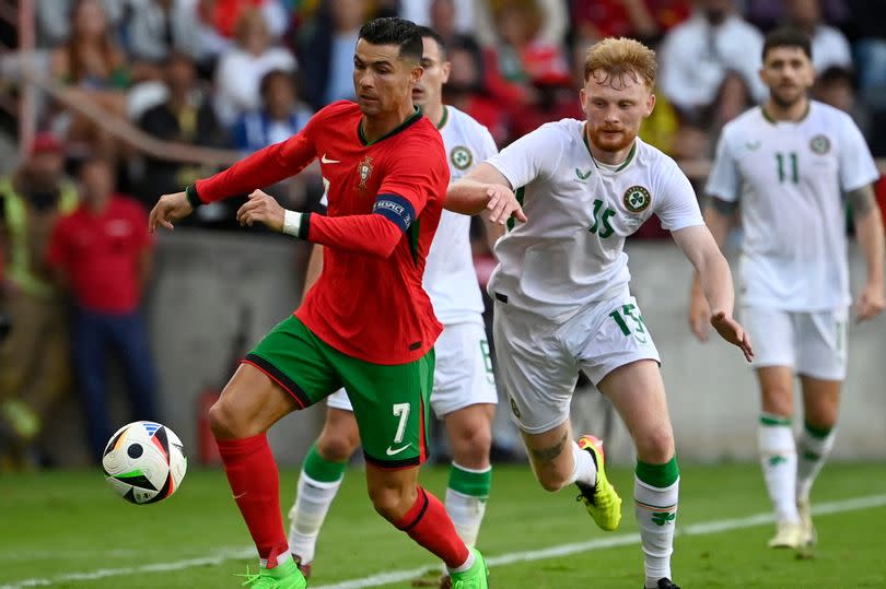 Portugal forward Cristiano Ronaldo vies with Ireland defender Liam Scales