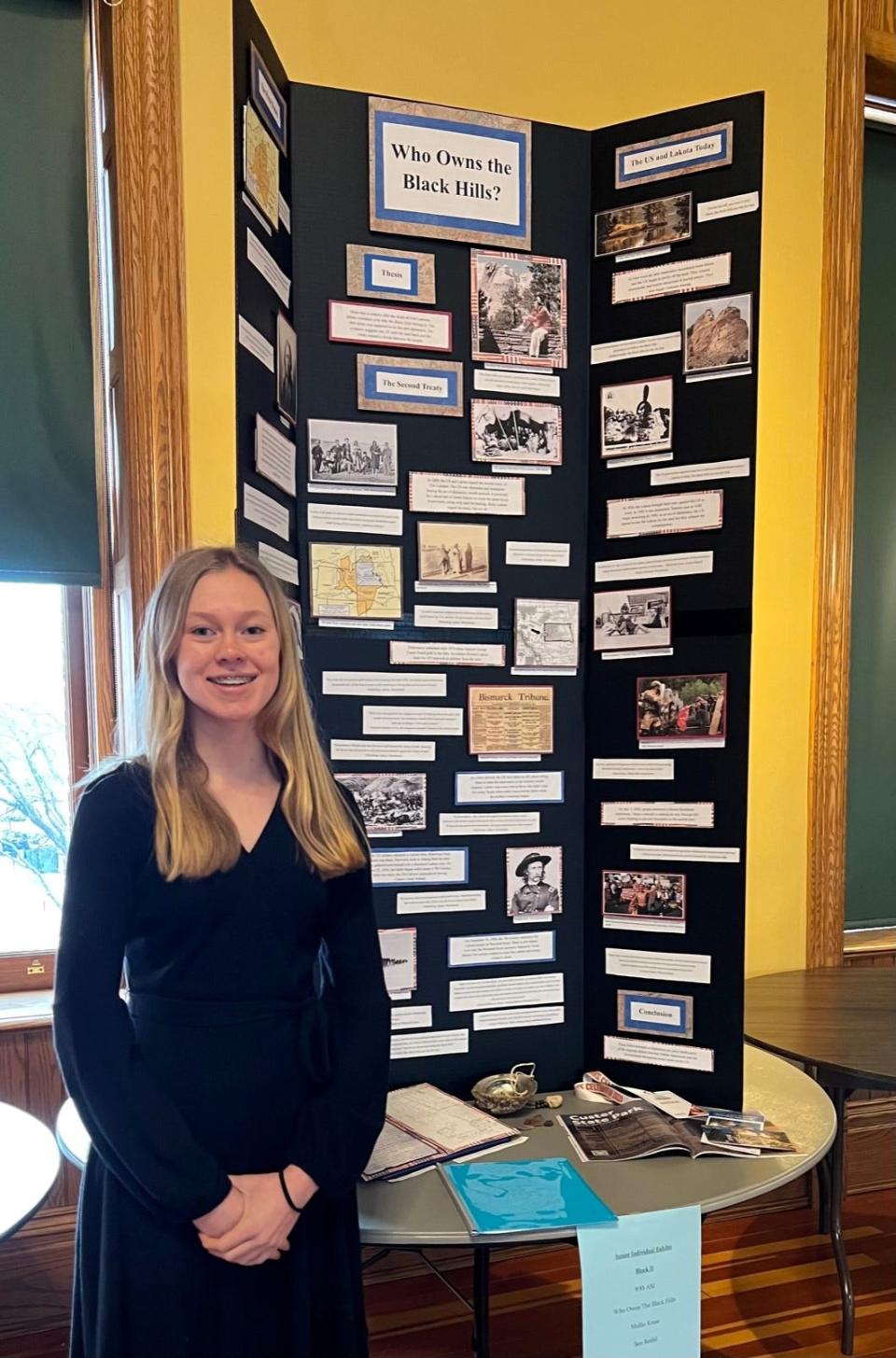 Mollie Kruse poses with her project "Who Owns The Black Hills," which is now part of a virtual showcase at the Smithsonian's National Museum of American History.