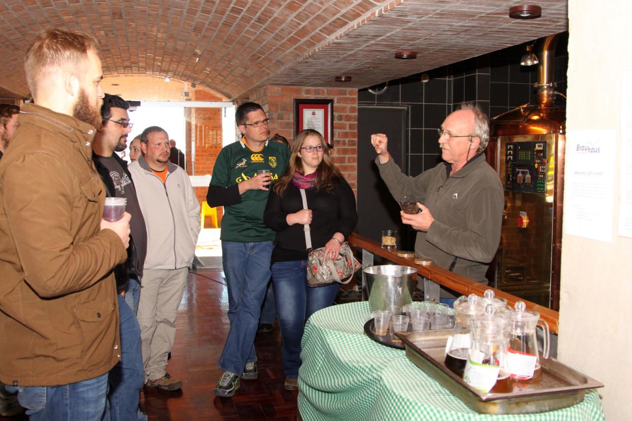 Kroondal, South Africa€“ - July 25, 2015: North West Winter Craft Beer Festival held at Brauhaus am Damm. Manager Walter Stallmann explaining process to tour group.