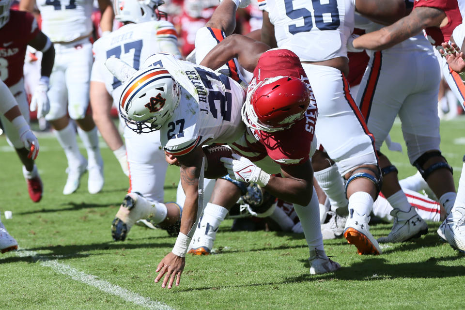 Oct 16, 2021; Fayetteville, Arkansas, USA; Arkansas Razorbacks defensive lineman Jashaud Stewart (58) forces a fumble while tackling <a class="link " href="https://sports.yahoo.com/ncaaf/teams/auburn/" data-i13n="sec:content-canvas;subsec:anchor_text;elm:context_link" data-ylk="slk:Auburn Tigers;sec:content-canvas;subsec:anchor_text;elm:context_link;itc:0">Auburn Tigers</a> running back <a class="link " href="https://sports.yahoo.com/ncaaf/players/325072" data-i13n="sec:content-canvas;subsec:anchor_text;elm:context_link" data-ylk="slk:Jarquez Hunter;sec:content-canvas;subsec:anchor_text;elm:context_link;itc:0">Jarquez Hunter</a> (27) at Donald W. Reynolds Razorback Stadium. Mandatory Credit: Nelson Chenault-USA TODAY Sports