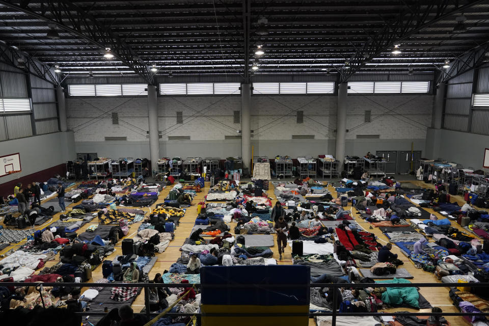 FILE - Ukrainian refugees wait in a gymnasium Tuesday, April 5, 2022, in Tijuana, Mexico. The Biden administration is allowing thousands of Ukrainians who fled their homeland when Russia invaded a year ago to stay in the United States longer. The administration announced the decision Monday, March 13, 2023. (AP Photo/Gregory Bull, File)