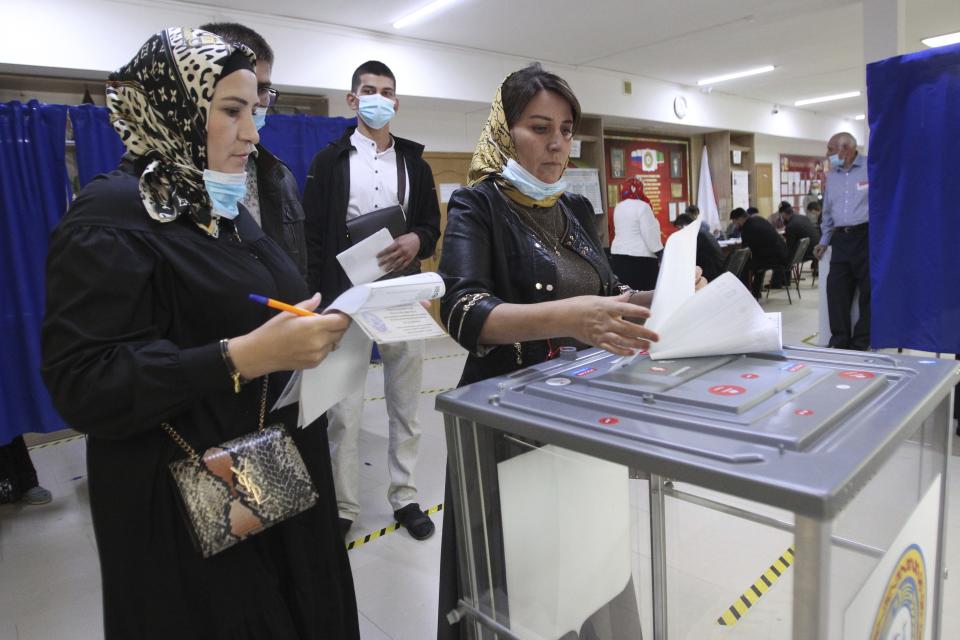 Chechen women cast their ballots at a polling station during the Parliamentary elections in Grozny, Russia, Friday, Sept. 17, 2021. Russia has begun three days of voting for a new parliament that is unlikely to change the country's political complexion. There's no expectation that United Russia, the party devoted to President Vladimir Putin, will lose its dominance in the State Duma. (AP Photo/Musa Sadulayev)