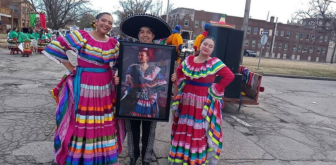 Members of Ballet Folklorico Mexico En El Corazon hold a portrait of Paoly Bedeski on Nov. 3 at the Our Lady of Guadalupe parade in Wichita.