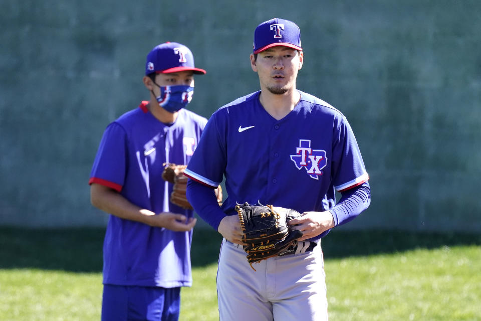 Texas Rangers pitcher Kohei Arihara, from Japan, walks to a drill during spring training baseball practice Wednesday, Feb. 24, 2021, in Surprise, Ariz. (AP Photo/Charlie Riedel)