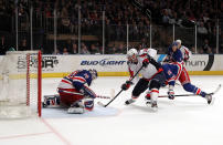 NEW YORK, NY - APRIL 30: Troy Brouwer #20 of the Washington Capitals attempts a shot on goal against goalie Henrik Lundqvist #30 of the New York Rangers in Game Two of the Eastern Conference Semifinals during the 2012 NHL Stanley Cup Playoffs at Madison Square Garden on April 30, 2012 in New York City. (Photo by Bruce Bennett/Getty Images)