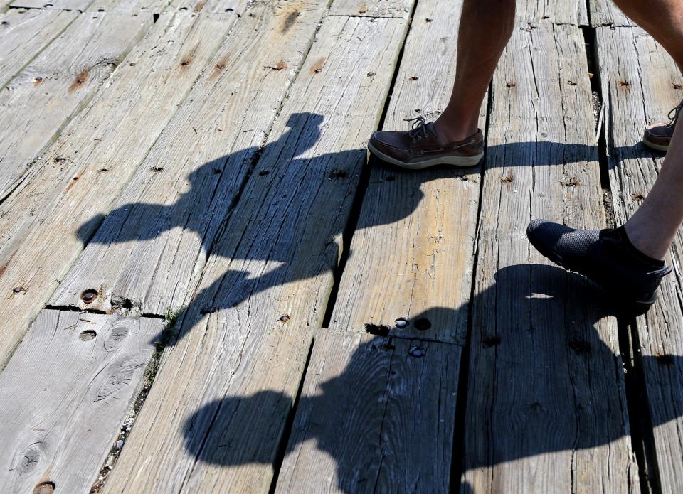 Sail Portsmouth Board Chair Phil Von Hemert casts his shadow on the Portsmouth Commercial Fishing Pier as he talks about the upcoming Sail Portsmouth festival in August.