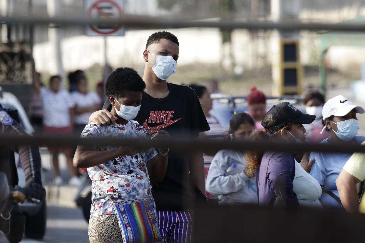 Relatives of prisoners await news outside the Litoral Penitentiary in Guayaquil, Ecuador, Wednesday, September 29, 2021. The authorities have reported at least 100 dead and 52 injured in a riot on Tuesday at the prison. (AP Photo/Angel DeJesus)