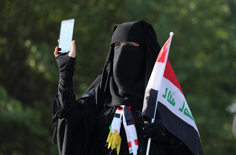 A woman takes part in ongoing anti-government protests at Tahrir Square in Baghdad, Iraq, Thursday, Oct. 31, 2019. (AP Photo/Hadi Mizban)