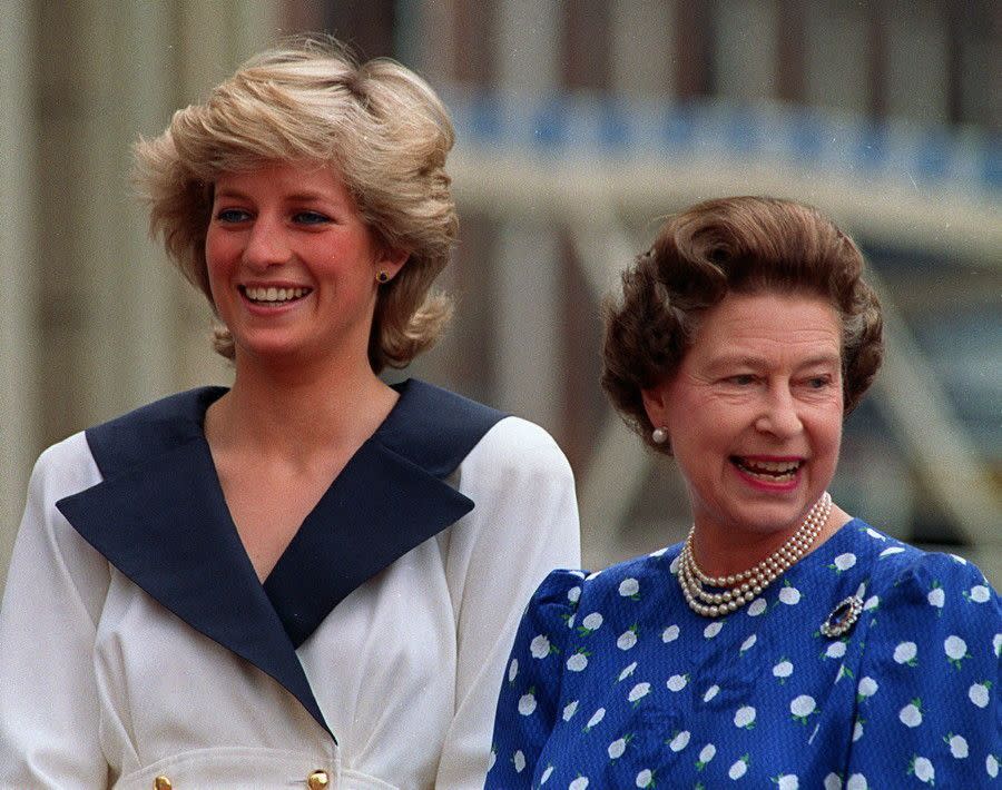 Queen Elizabeth stands next to Diana, Princess of Wales, while smiling to well-wishers outside Clarence House in London on Aug. 4, 1987.