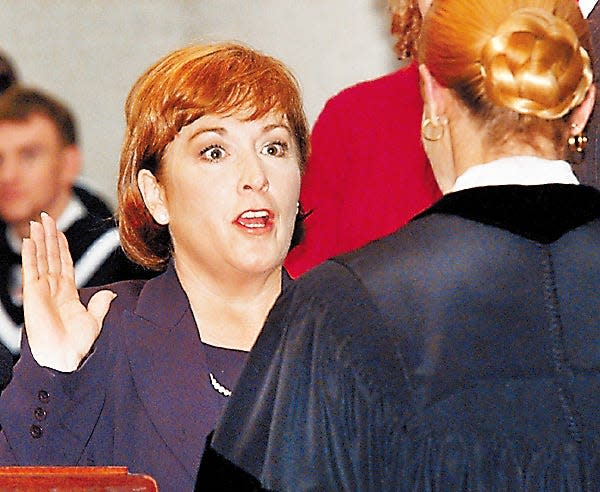 Gov. Nancy Hollister is sworn in by Justice Evelyn L. Stratton in the atrium of the Statehouse on Dec. 31, 1998.