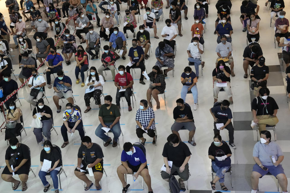 Residents wait for a dose of the Pfizer-BioNTech COVID-19 vaccine in Bangkok, Thailand, Wednesday, Aug. 25, 2021. Thailand has recorded more than 1 million accumulated cases on last week since the pandemic started in 2020. (AP Photo/Sakchai Lalit)