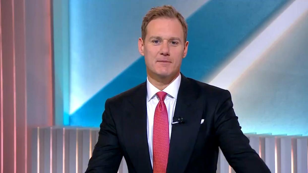 dan walker in a suit and tie presenting 5 news