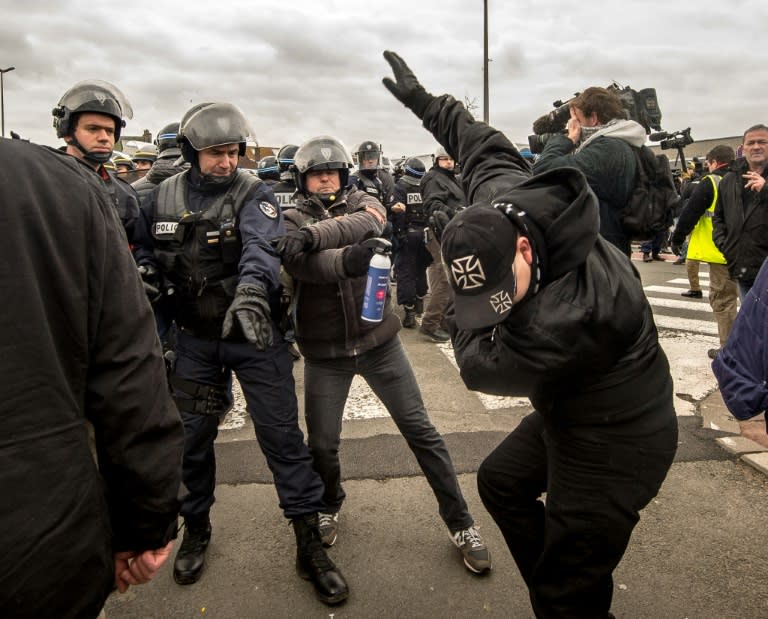 Policemen arrest a supporter of the Pegida movement (Patriotic Europeans Against the Islamisation of the Occident) during a demonstration in Calais, northern France on February 6, 2016