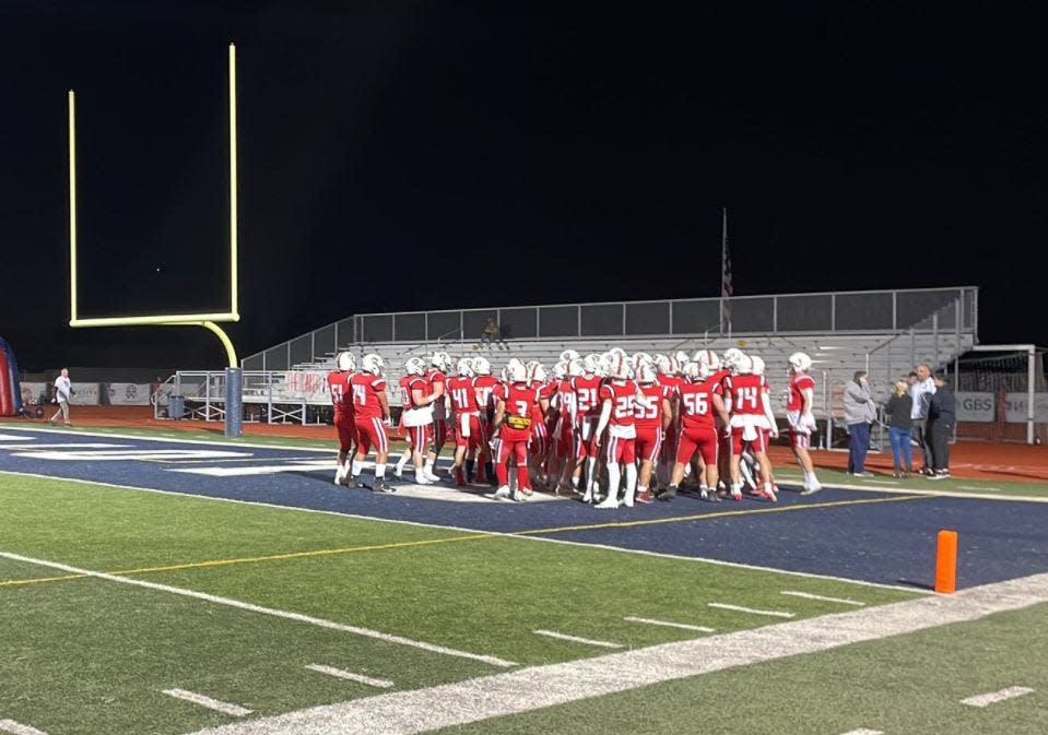 ALA-Queen Creek's football team gathers in the end zone ahead of their game against Horizon on Thursday, Nov. 10, 2022.