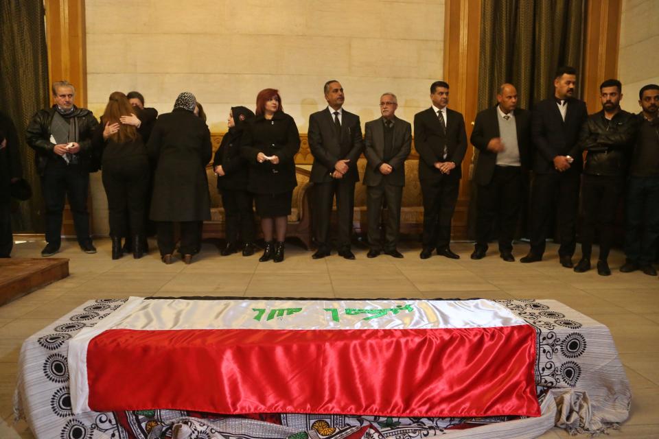 Staff of the Iraq Museum attend the funeral procession of archaeologist Lamia al-Gailani in the Iraqi National Museum in Baghdad, Iraq, Monday, Jan. 21, 2019. Iraq is mourning the loss of a beloved archaeologist who helped rebuild her country's leading museum in the aftermath of the U.S. invasion in 2003. (AP Photo/Khalid Mohammed)