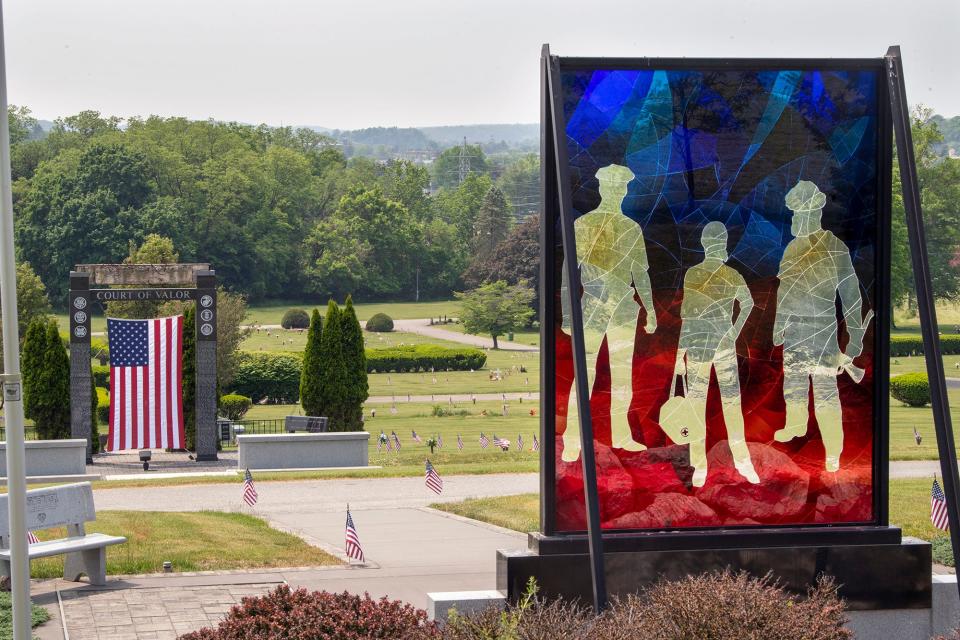 Looking south through the Safekeepers Shrine, right, and the Court of Valor (911 memorial) at left, that contains a beam from the Twin Towers at Prospect Hill Cemetery on May 23, 2023 in Manchester Township. The memorials overlook the site of a potential warehouse or other industrial development at the bottom of the hill.