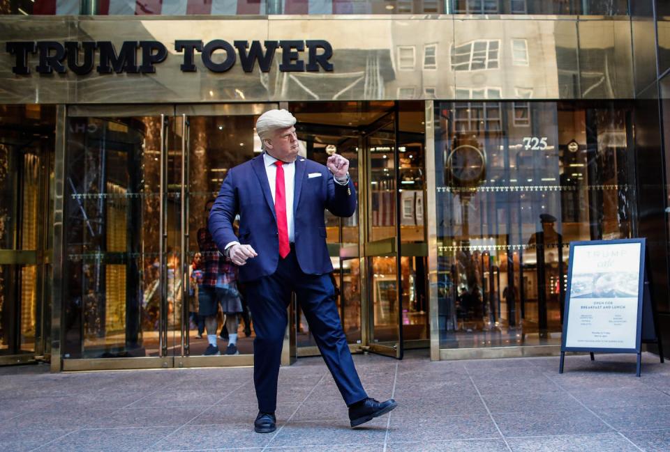 A man wearing a Donald Trump face mask poses outside Trump Tower on April 2, 2023, in New York. <a href="https://media.gettyimages.com/id/1250626840/photo/new-york-grand-jury-votes-to-indict-former-president-trump.jpg?s=1024x1024&w=gi&k=20&c=vknGVWkJc0qRcNSI94t8RaM8_Wl5iU8r_Nu3NKaZJ58=" rel="nofollow noopener" target="_blank" data-ylk="slk:Kena Betancur/Getty Images;elm:context_link;itc:0;sec:content-canvas" class="link ">Kena Betancur/Getty Images</a>