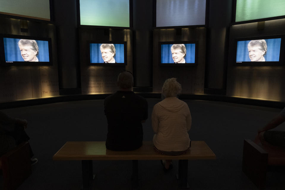 People watch a film in The Carter Center's museum during a celebration for President Jimmy Carter's 99th birthday held at the center in Atlanta on Saturday, Sept. 30, 2023. (AP Photo/Ben Gray)