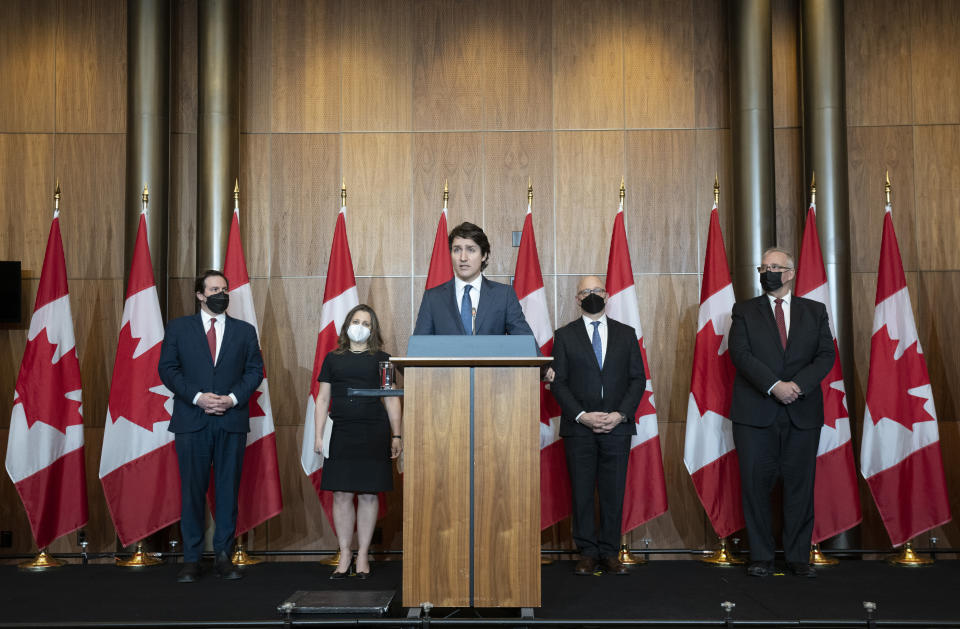 Prime Minister Justin Trudeau speaks during a news conference, Monday, Feb. 21, 2022 in Ottawa, accompanied by, background from left, Public Safety Minister Marco Mendicino, Deputy Prime Minister and Finance Minister Chrystia Freeland, Justice Minister and Attorney General of Canada David Lametti and President of the Queen's Privy Council for Canada and Emergency Preparedness Minister Bill Blair. (Adrian Wyld/The Canadian Press via AP)