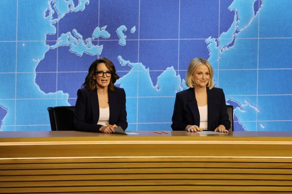 Saturday Night Live veterans Tina Fey and Amy Poehler reunite to co-anchor a Weekend Update segment during the 75th Primetime Emmy Awards on Monday evening, presenting the award for outstanding variety special (live).