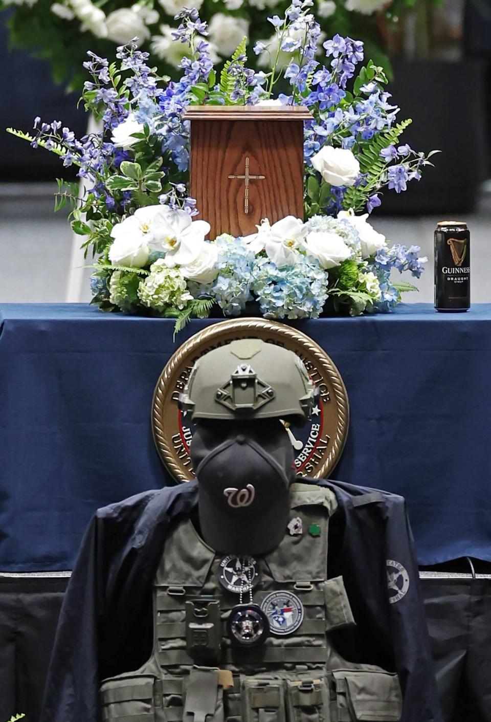 U.S. Deputy Marshal Thomas Weeks Jr.’s, gear and remains stand during a memorial to the slain officer at Bojangles Coliseum in Charlotte, NC on Monday, May 6, 2024. Weeks died during a standoff with a gunman on Monday, April 29th 2024. Two other law enforcement officers were also killed in the shootout. CMPD Officer Joshua Eyer passed away later Monday evening from injuries sustained during the shootout.