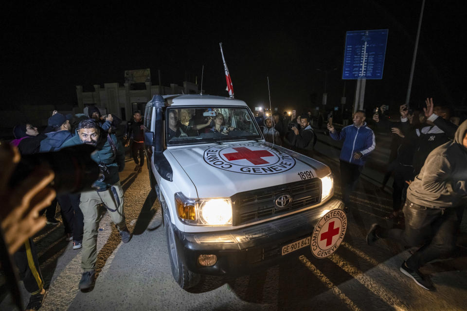 A Red Cross convoy carrying Israeli and foreign hostages heads to Egypt from the Gaza Strip at the Rafah border crossing on Sunday, Nov. 26, 2023. (AP Photo/Fatima Shbair)